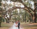 What a breathtaking display of a newlywed couple standing beneath live oak trees. 